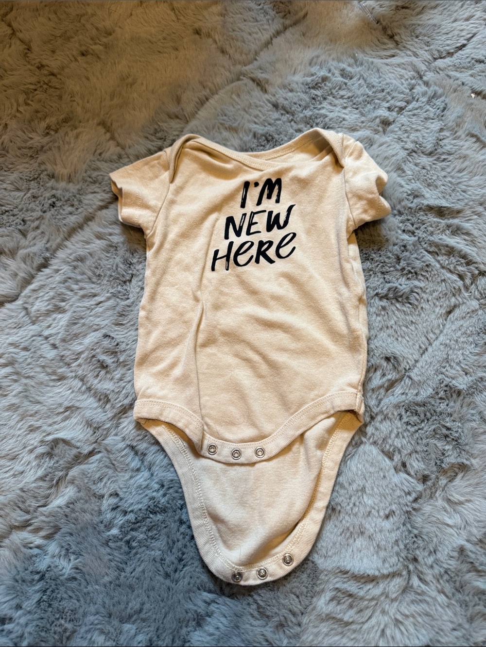Cream Baby One-Piece Bodysuit with "I'm New Here" Print